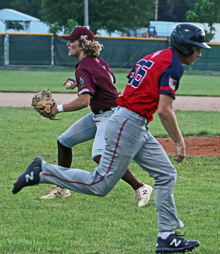 Arlington Senior Legion first baseman Nick Smith, left, picks up the South Sioux City base runner's bunt and looks to home plate for a force out Monday at the Washington County Fairgrounds.