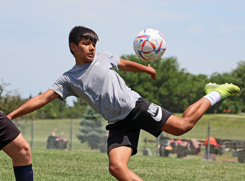 Victor Hernandez, 13, stretches to boot the ball out of the air Tuesday during an afternoon session of the Paul Cox Soccer Camp at the Blair Youth Sports Complex.