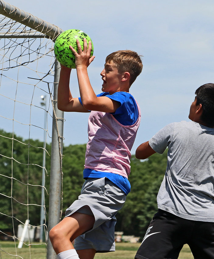 Goalkeeper Aiden McBreen, 14, nabs the ball out of the air Tuesday at the Blair Youth Sports Complex.
