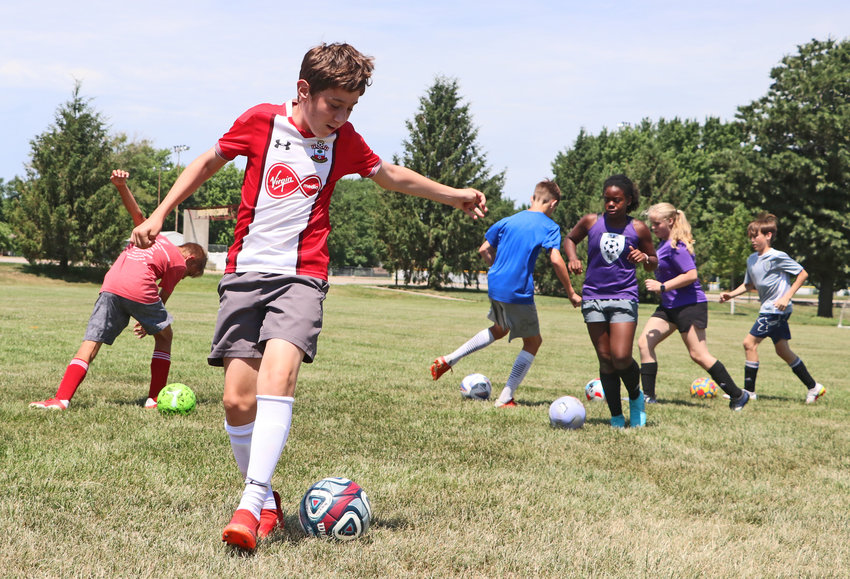 Hayden Olsen, 13, front left, plays with the ball at his feet Tuesday at the Blair Youth Sports Complex.