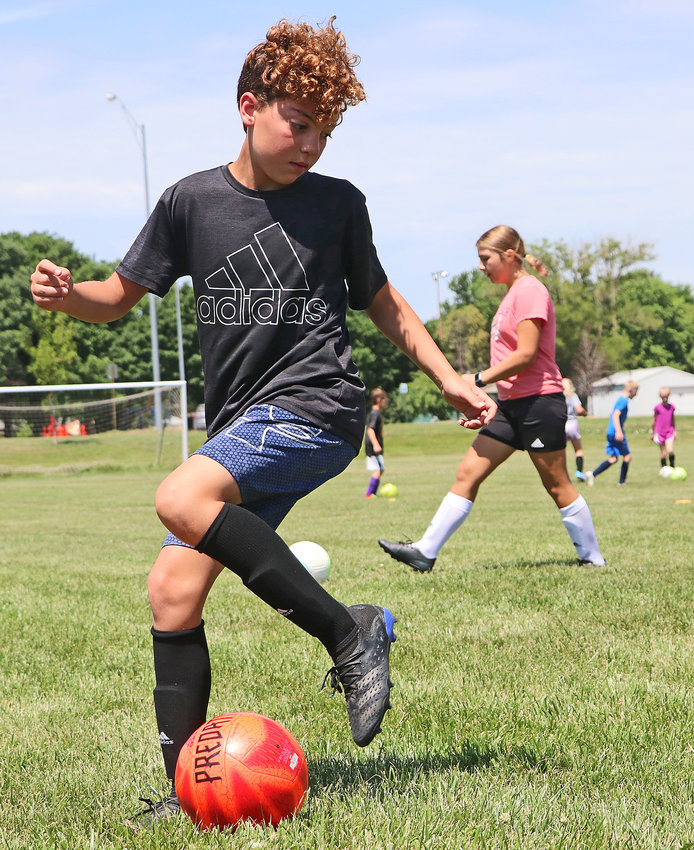 Parker Madden, 11, works on his possession skills Tuesday at the Blair Youth Sports Complex.