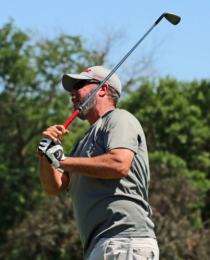 Dale Skeen watches his No. 7 tee shot Wednesday during league play at River Wilds Golf Club.