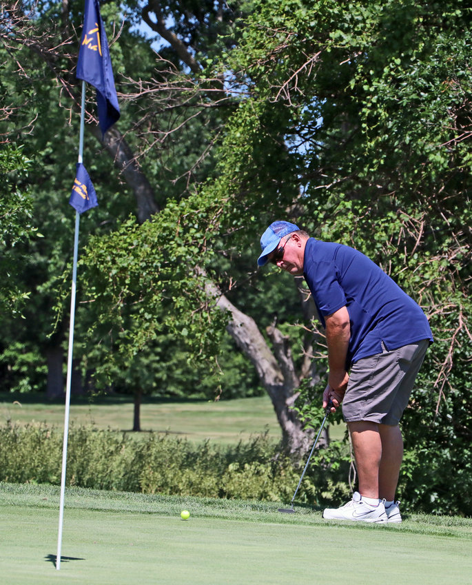 Dan McCaig hits his ball from the No. 7 fringe Wednesday at River Wilds Golf Club.