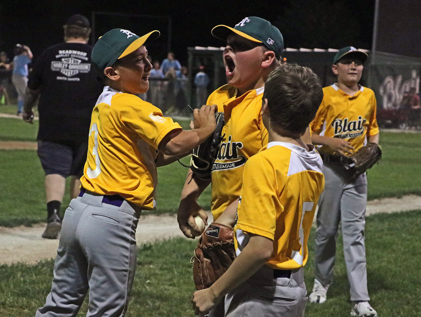 Blair Little League A's Trace Stratman, from left, Drake Jennings, Donovan Maggio and Tyce Larsen celebrate their Major League division tournament title Tuesday at Wederquist Field.