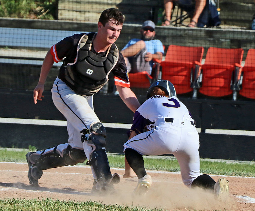 Post 348 Junior Legion catcher Jeffery Pringle, left, tags out a Louisville/Weeping Water base runner at the plate Wednesday in Fort Calhoun.