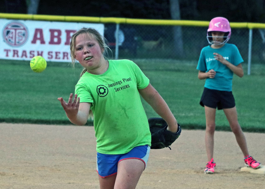 Jazmayn Howell, left, of Jennings Plant Services pitches June 30 at the Youth Sports Complex.