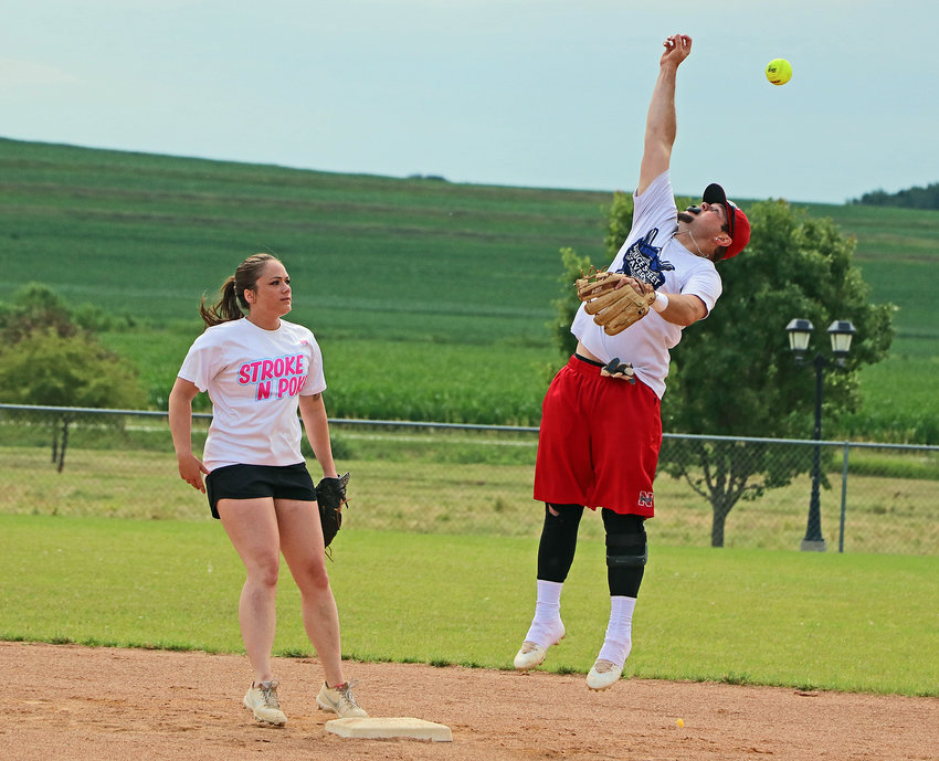 Shay Boudle, right, leaps for a high throw as Amanda Osborn lends support at second base Saturday during Arlington Summer Sizzle softball play at Two Rivers Sports Complex.