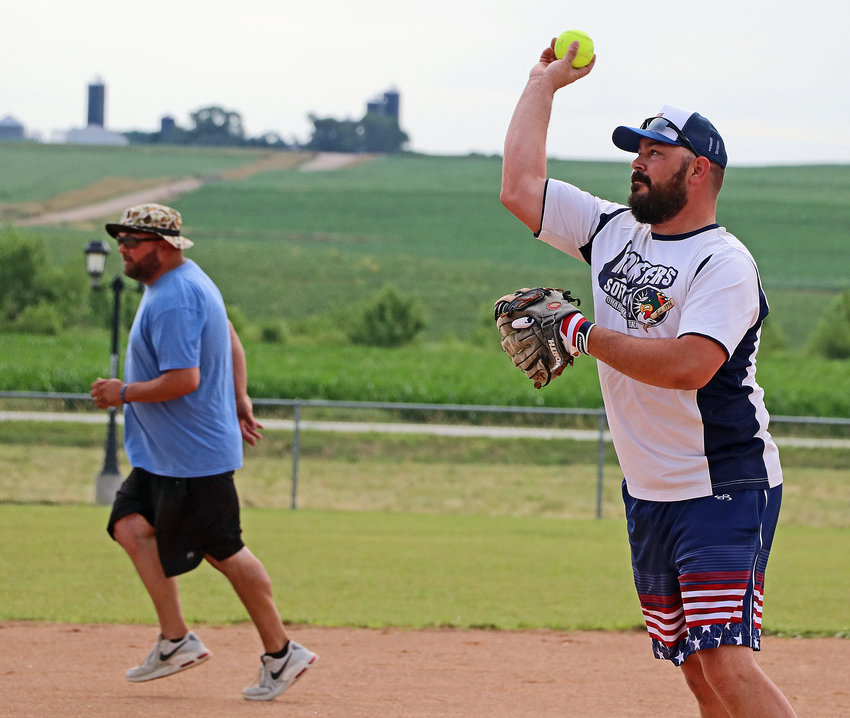 JJ Mastny, right, plays softball Saturday morning during the Arlington Summer Sizzle celebration.