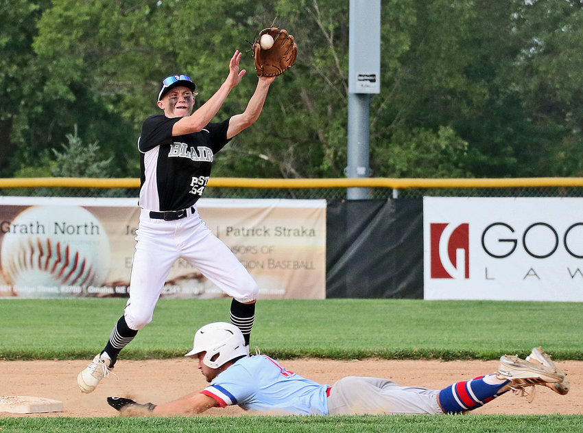 Blair Junior Legion infielder Carter Saylor, left, leaps for a high throw to second base Friday at Elkhorn Mount Michael.