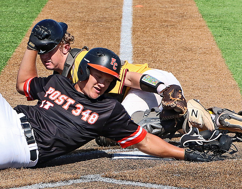 Fort Calhoun Junior Legion base runner Alex Christensen, front, tries to slide past the Kelly Ryan Pride catcher and across home plate Saturday in Plattsmouth.