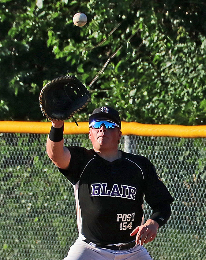 Blair Legion first baseman Dylan Swanson nabs a throw for an out Monday at the Washington County Fairgrounds.
