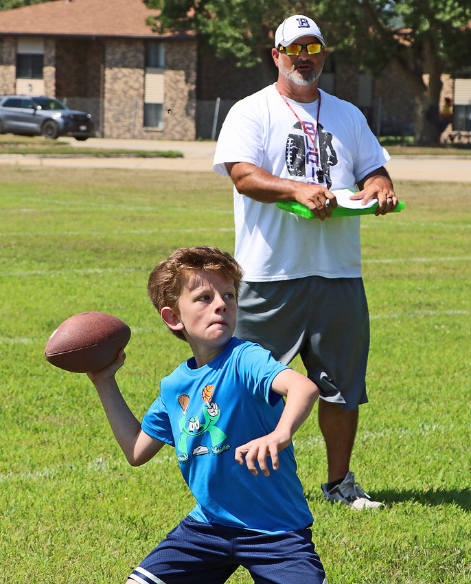 Charlie Paper, 9, throws in front of coach Bryan Soukup on Tuesday at Blair High School.