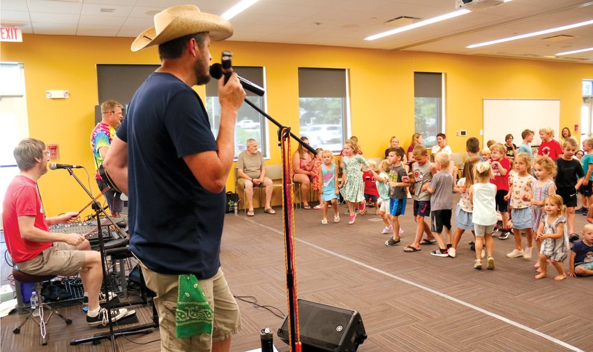 Children dance and sing along to the String Beans at the Blair Public Library and Technology Center on July 19. The String Beans were last weekly program at the library for this year's summer reading program, which wraps up Friday.