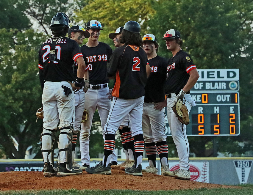 The Fort Calhoun Senior Legion baseball team meets on the mound Friday during the Class B Area 3 Tournament at Vets Field.