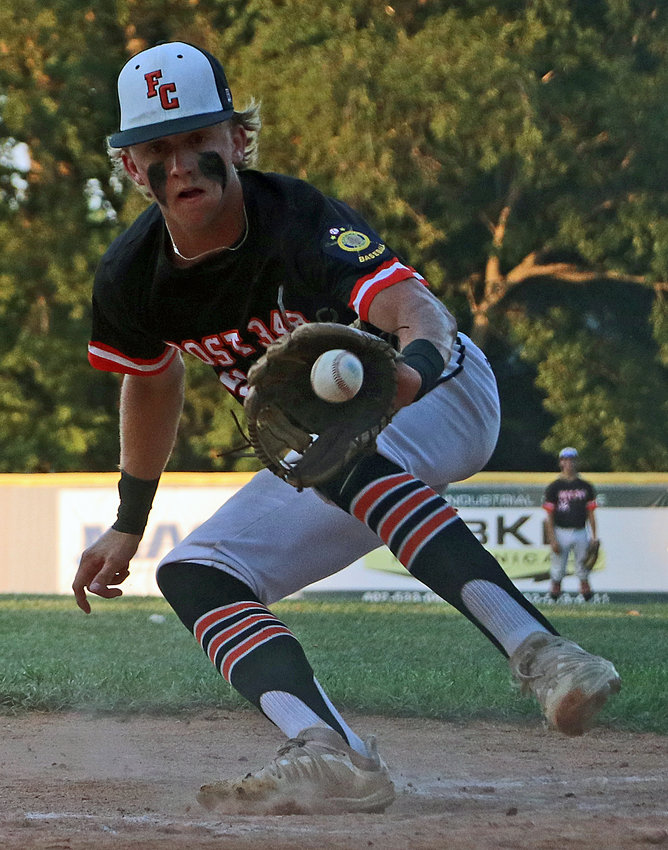 Fort Calhoun pitcher Ty Hallberg snags the ball in hopes of turning to home plate for a tag Friday at Vets Field.