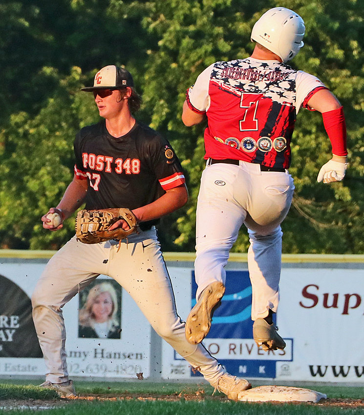 Fort Calhoun first baseman Carter Christensen, left, is able to beat Blair's Morgan Rump to the bag Friday at Vets Field.