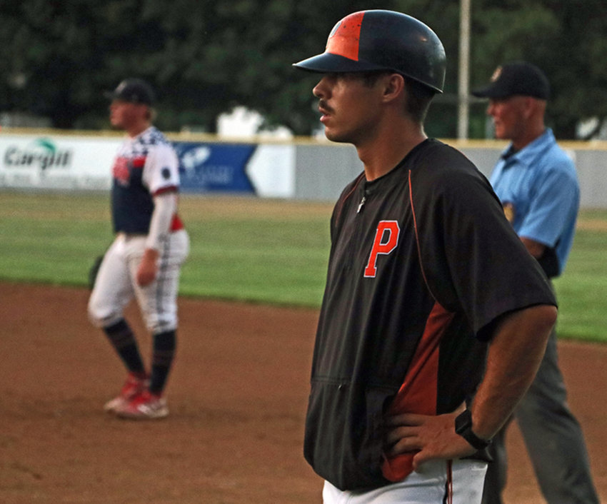 Fort Calhoun first base coach Jamie Warner watches play Friday at Vets Field.