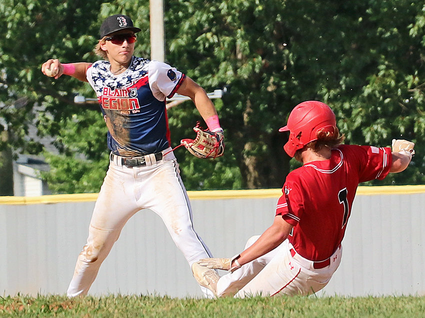 Blair Senior Legion infielder Greyson Kay, left, throws the ball from second to first base Tuesday at Vets Field.