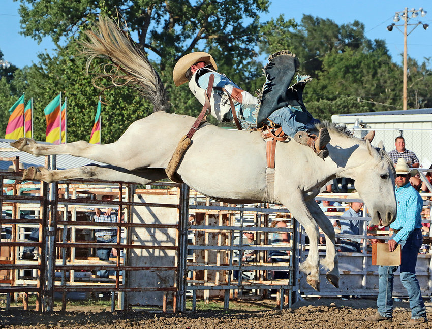 Austin Rose of Guide Rock attempts to ride a McKay Rodeo Company bucking horse Saturday at the Washington County Fairgrounds.