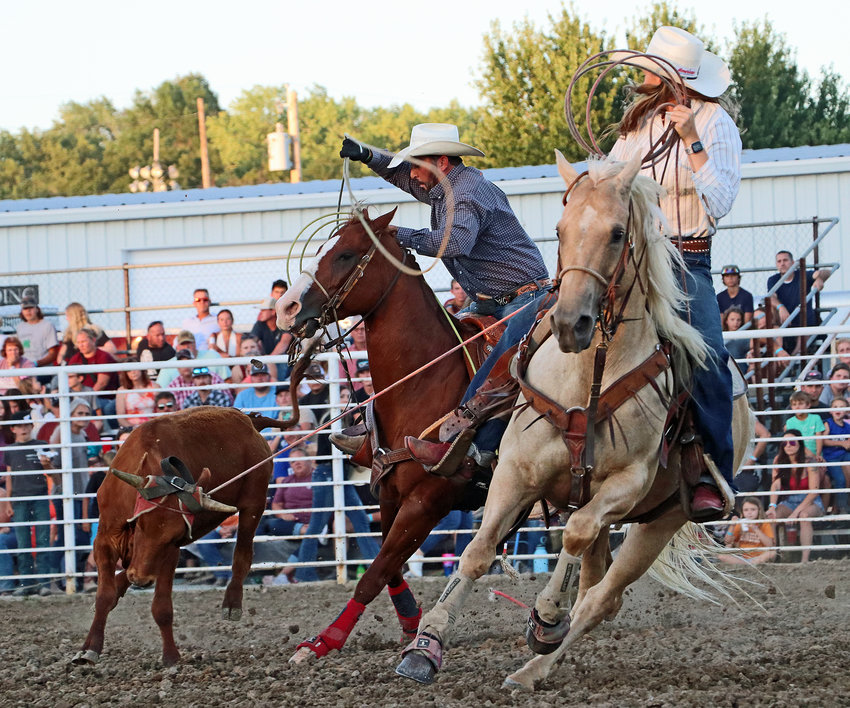 Harry, left, and Bradie Crouse of Blair compete in mixed-team roping Saturday at the Washington County Fairgrounds.