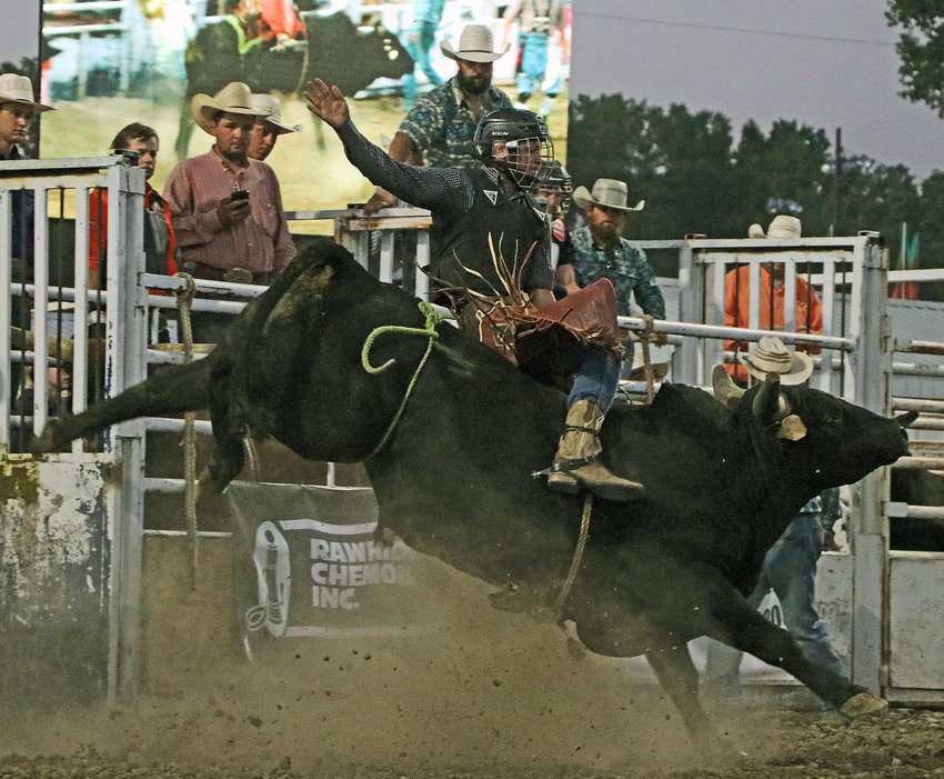 Dillon Dierks of Fort Calhoun competes in the bull riding Saturday at the Washington County Fairgrounds.
