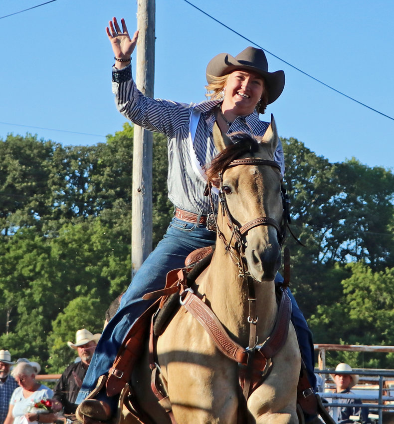 Washington County Rodeo Queen Cassidy Arp waves to the crowd Saturday in Arlington.