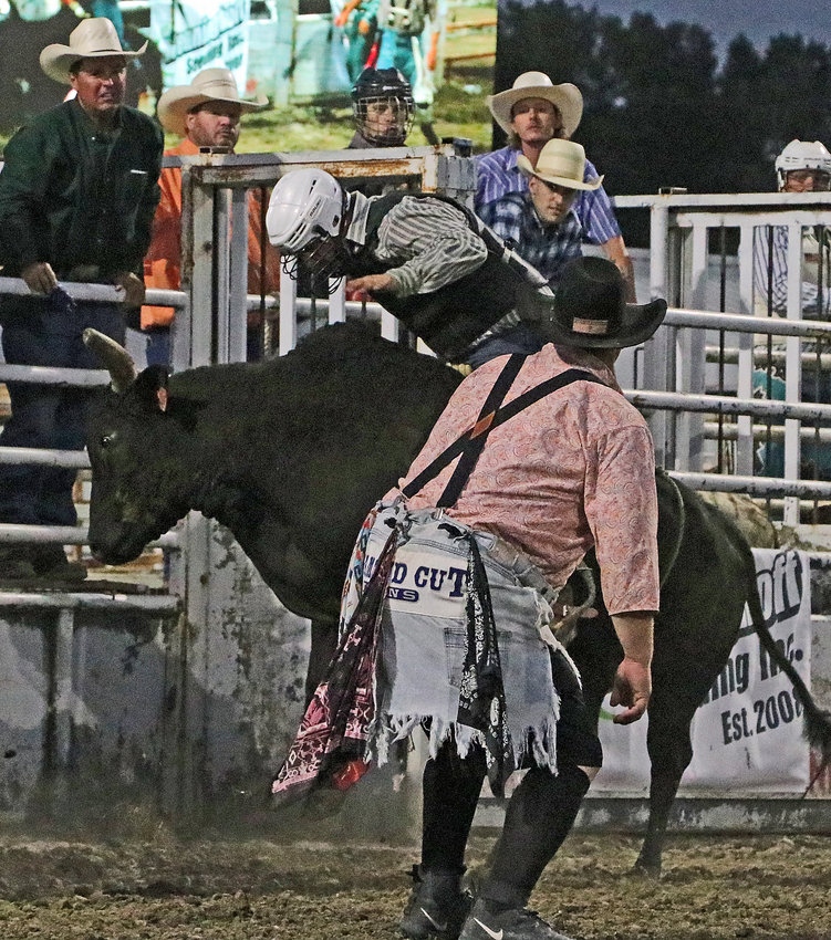 Jesse Hartline of Fort Calhoun rides a bull Saturday at the Washington County Fairgrounds.