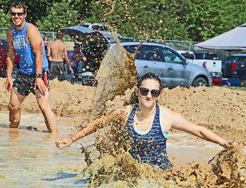 Mud flies as Rachel Ryckman of Arlington chases the ball Sunday at the Washington County Fairgrounds.