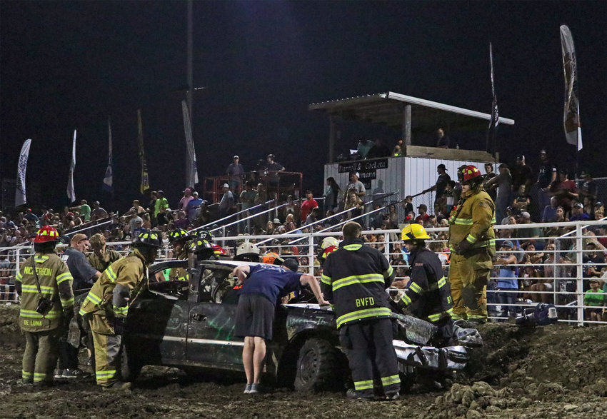 Emergency personnel assist an injured driver Wednesday during a demolition derby at the Washington County Fairgrounds.