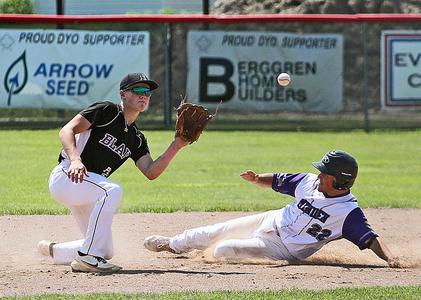 Blair Legion infielder Tanner Jacobson, left, watches in a throw Sunday during the Class B state tournament in Broken Bow.