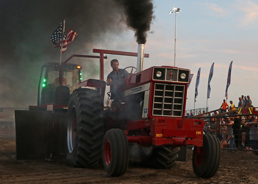 Max Greunke of Arlington drives a Farmall 1066 tractor Tuesday during the Golden Harvest Tractor Pull at the Washington County Fairgrounds.