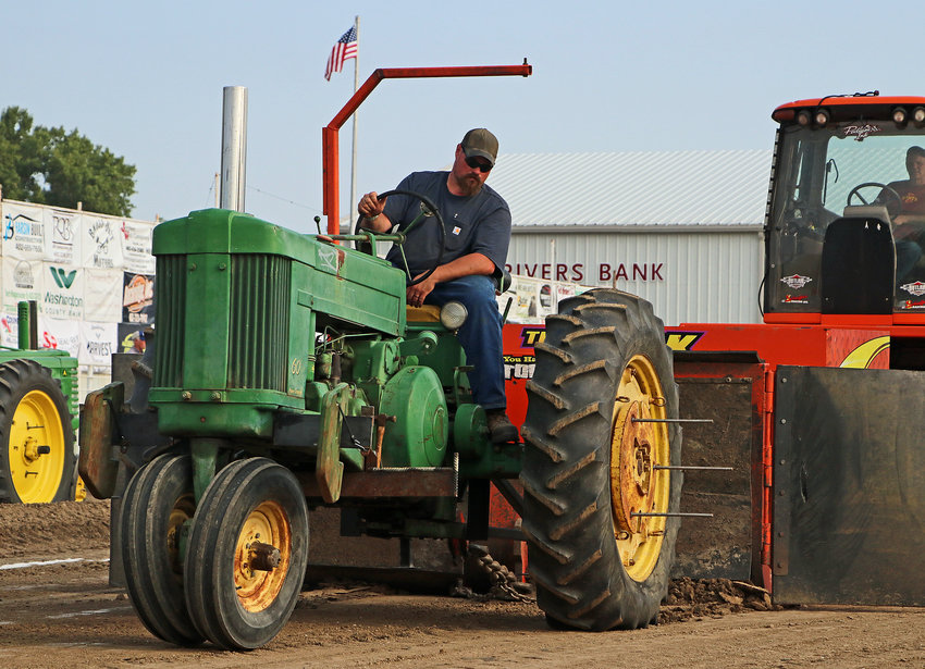 Garrett Villwok of Arlington pulls with his 1955 John Deere 60 tractor Monday during Antique Tractor & Pickup Pull at the Washington County Fairgrounds.