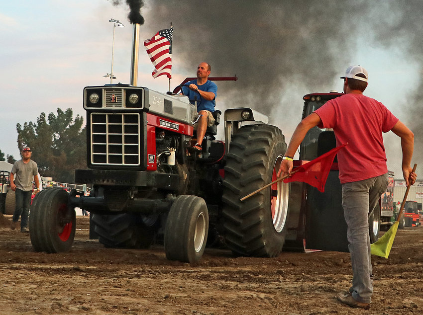 Jason Reinke of Columbus drives his 1466 Farmall tractor Tuesday at the Washington County Fairgrounds.