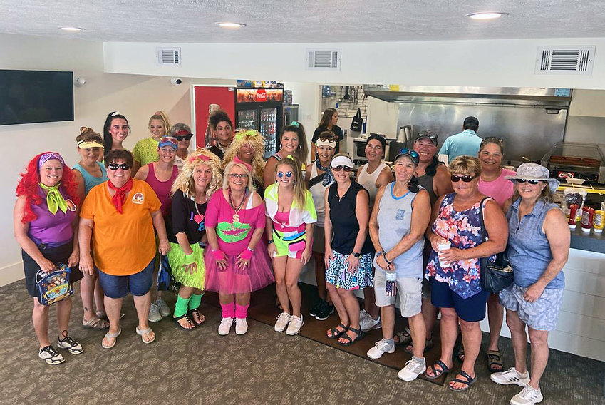 Golfers dressed in 1980s attire for Saturday's Ladies 4th Annual Golf Tournament at River Wilds Golf Club.