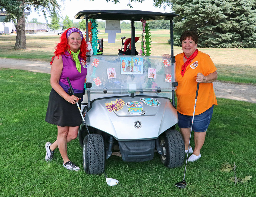 Robin Andreasen of Kennard, left, and Cora Thelen of Omaha dressed in Scooby-Doo attire for the 1908s-themed Ladies Golf Tournament at River Wilds Golf Club on Saturday.