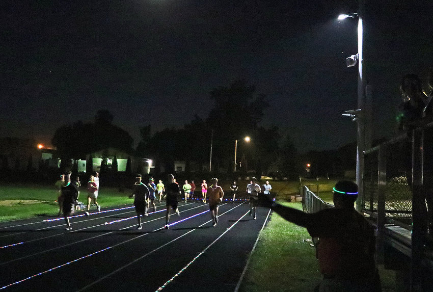 Night and rope lights lead the way for the Pioneers' first cross-country practice of the season Monday at Fort Calhoun High School.
