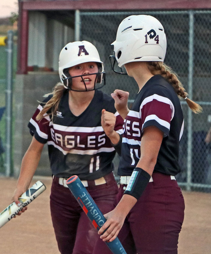Arlington's Emery McIntosh, left, and Kiersten Taylor celebrate a run scored in 2021. They are among the Eagles' top returners in 2022.