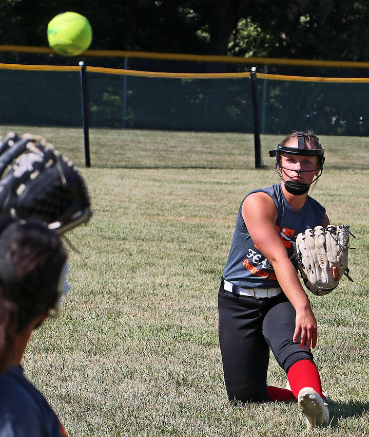 Anna Taylor, right, plays catch with Adriana Hernandez to start practice Aug. 10 in Fort Calhoun.