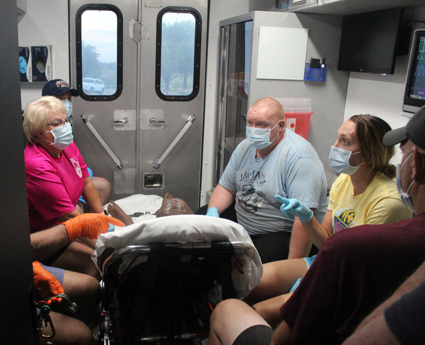 Members of the Arlington Volunteer Fire Department practice on patient simulators Aug. 24 at the fire station with SIM-NE, a free program with the University of Nebraska Medical Center aimed at helping to train rural fire and rescue departments for a variety of emergency situations.