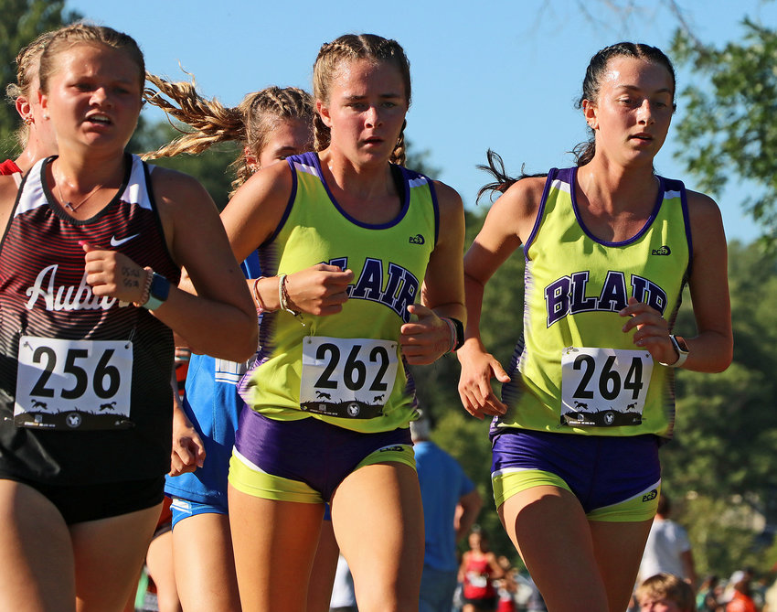 Blair's Allie Czapla, middle, and Reece Ewoldt, right, race side-by-side Tuesday at Rhylander Park in Plattsmouth.