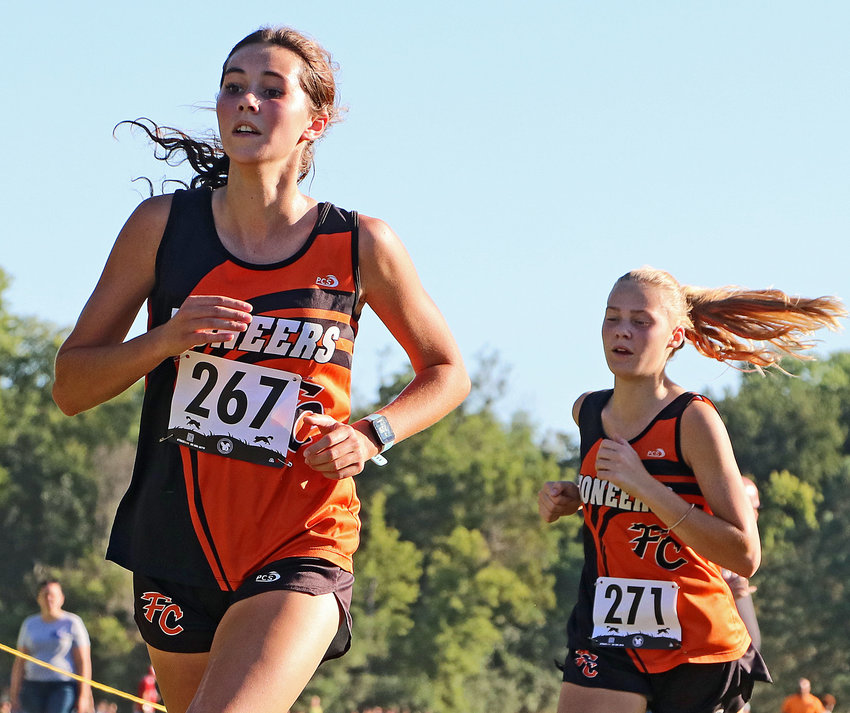 Fort Calhoun's Bria Bench, left, and Maelie Nelson finish Tuesday's race in Plattsmouth.