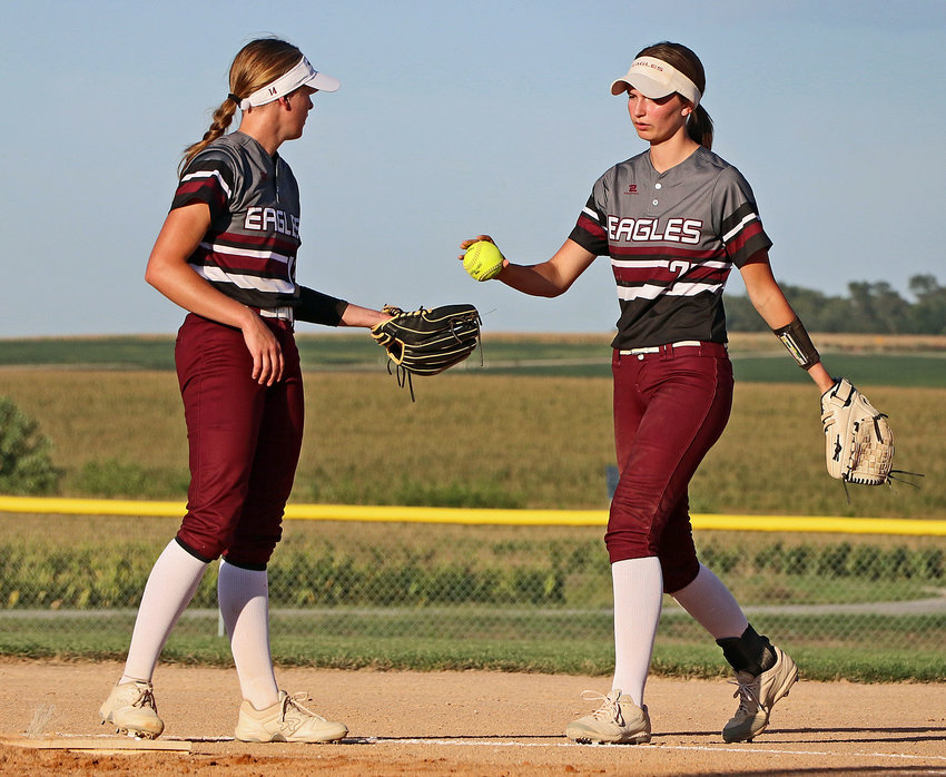 Arlington's Britt Nielsen, right, returns the ball back to her pitcher, Kiersten Taylor, on Thursday at Two Rivers Sports Complex.