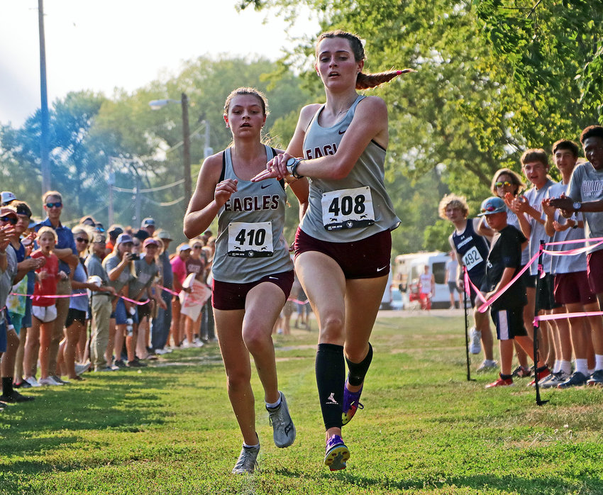 Arlington cross-country runners Keelianne Green, right, and Hailey O'Daniel race to the finish line Thursday at the Washington County Fairgrounds.