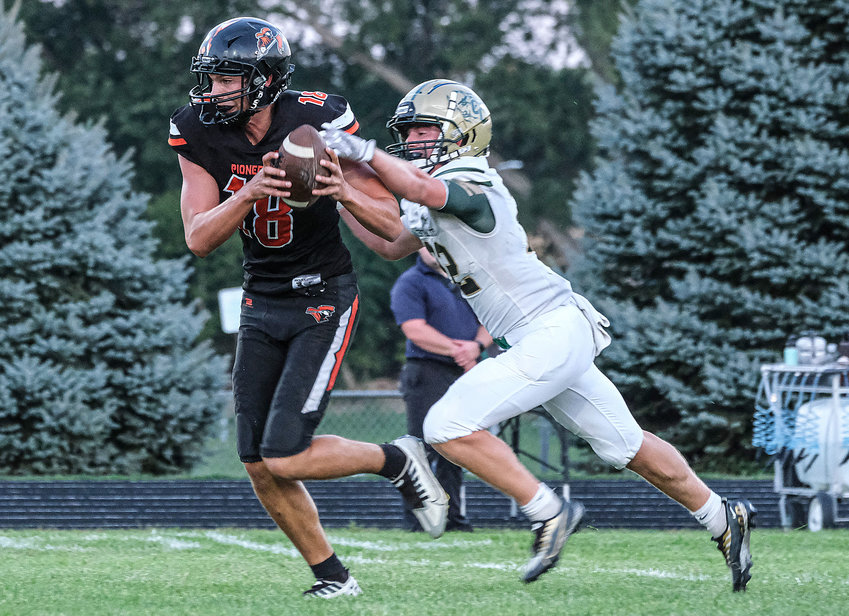 The Pioneers' Wyatt Appel, left, carries the ball after a first quarter catch Friday against Central City at Fort Calhoun High School.