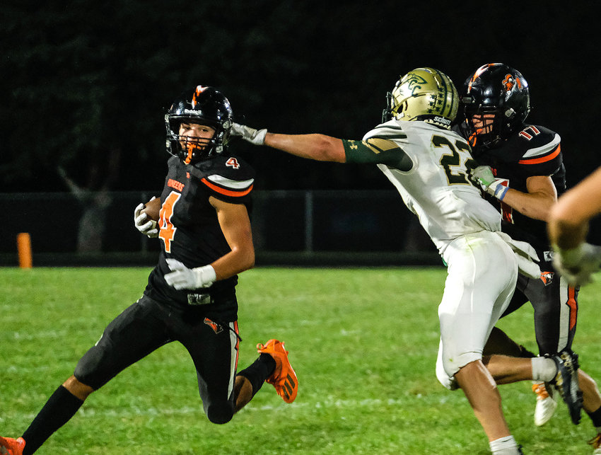 Pioneers freshman Blake Welchert, left, carries the ball as Avery Quinlan, right, battles with a Central City Bison on Friday at Fort Calhoun High School.