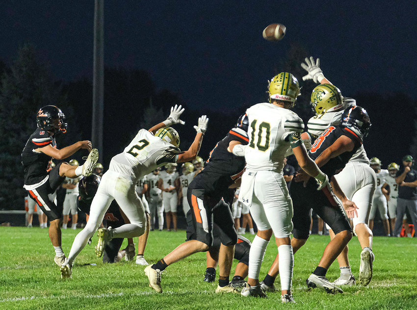 The Pioneers' Mason Bliss, left, makes an extra-point kick Friday at Fort Calhoun High School.