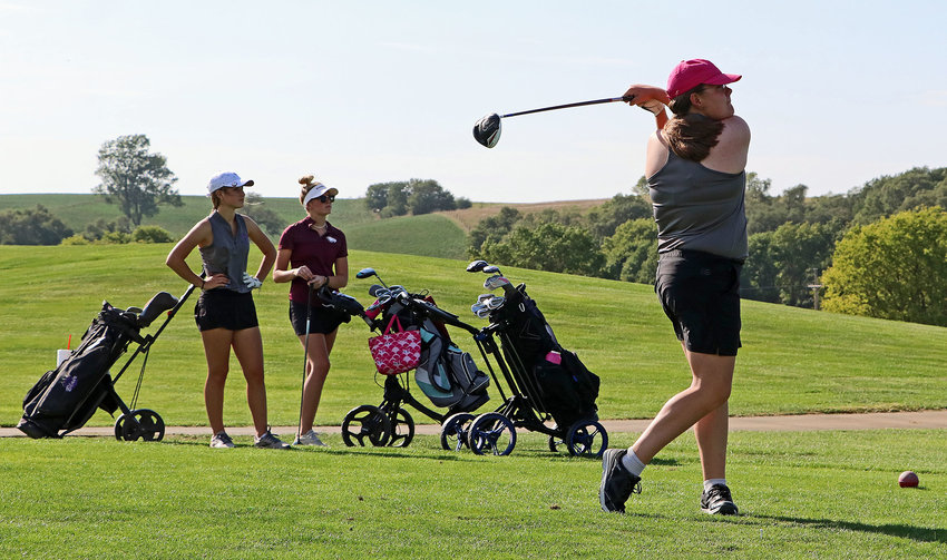 Blair's Diane Mitchell, right, tees off on No. 1 as Quinn Thompson, left, and Arlington's Grace Jones watch Thursday at River Wilds Golf Club.
