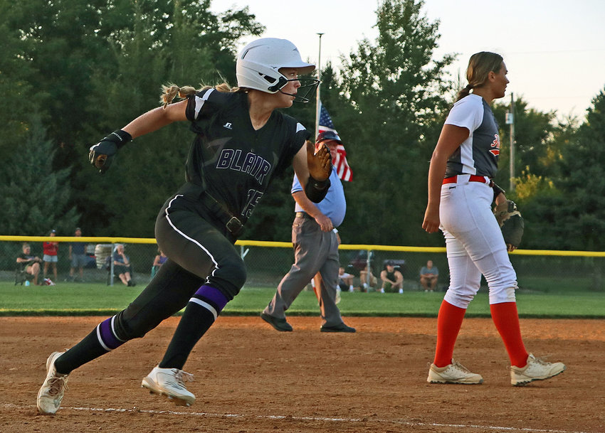 Blair base runner Nessa McMillen, left, rounds third base and heads home against Hastings on Monday at the Youth Sports Complex.