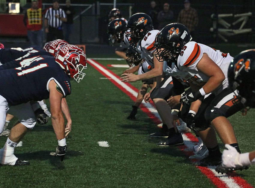 Fort Calhoun's offensive line — including Colby Bentley (64) and Colton Miles (55) — faces the Trojan defensive line Friday at Platteview High School.