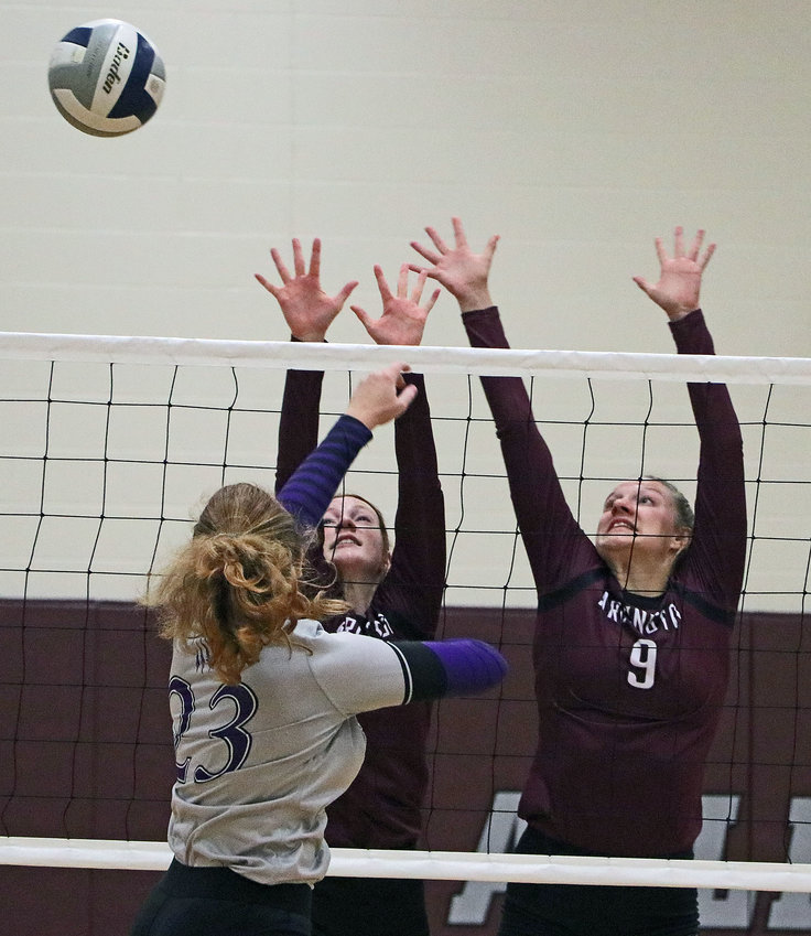 Blair's Norah Cloudt, left, tries to attack around the block of the Eagles' Callee Shearer, middle, and Lizzie Meyer at Arlington High School.